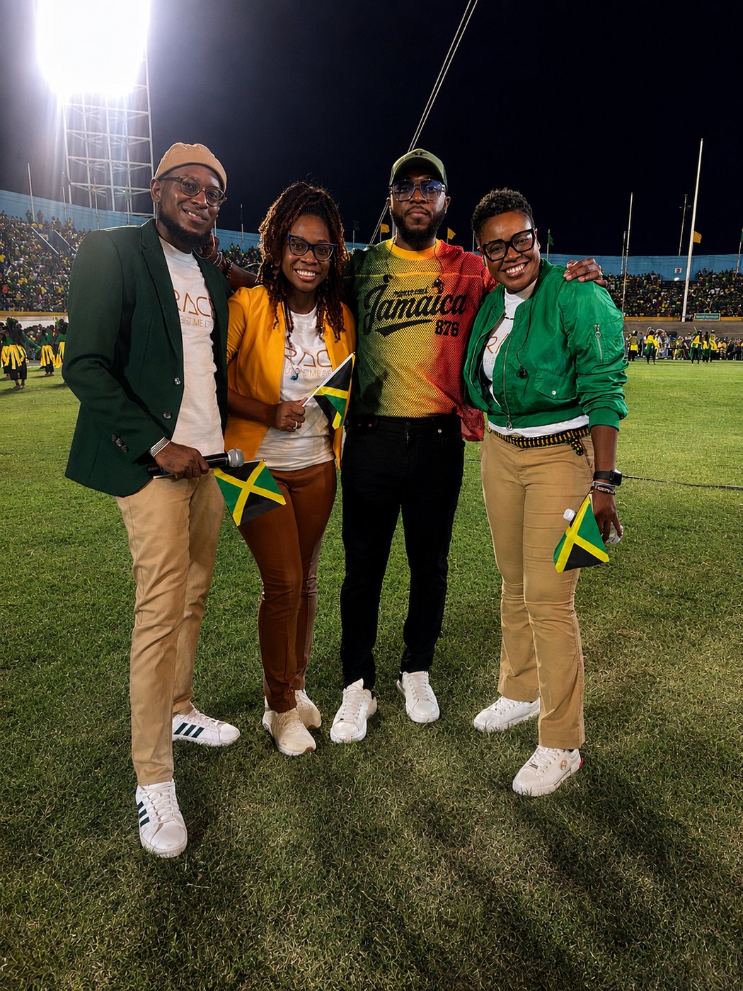 Kevin Downswell on the field of a full national stadium at night, Jamaican flags raised